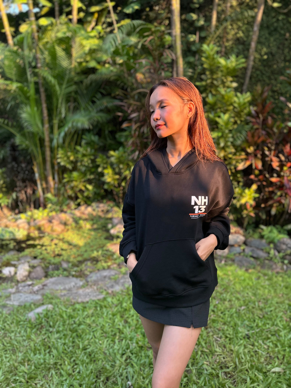 NH13 black hoodie worn by model, front view